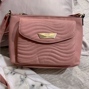 Multiple different brand handbags. Various colors with multiple pockets.